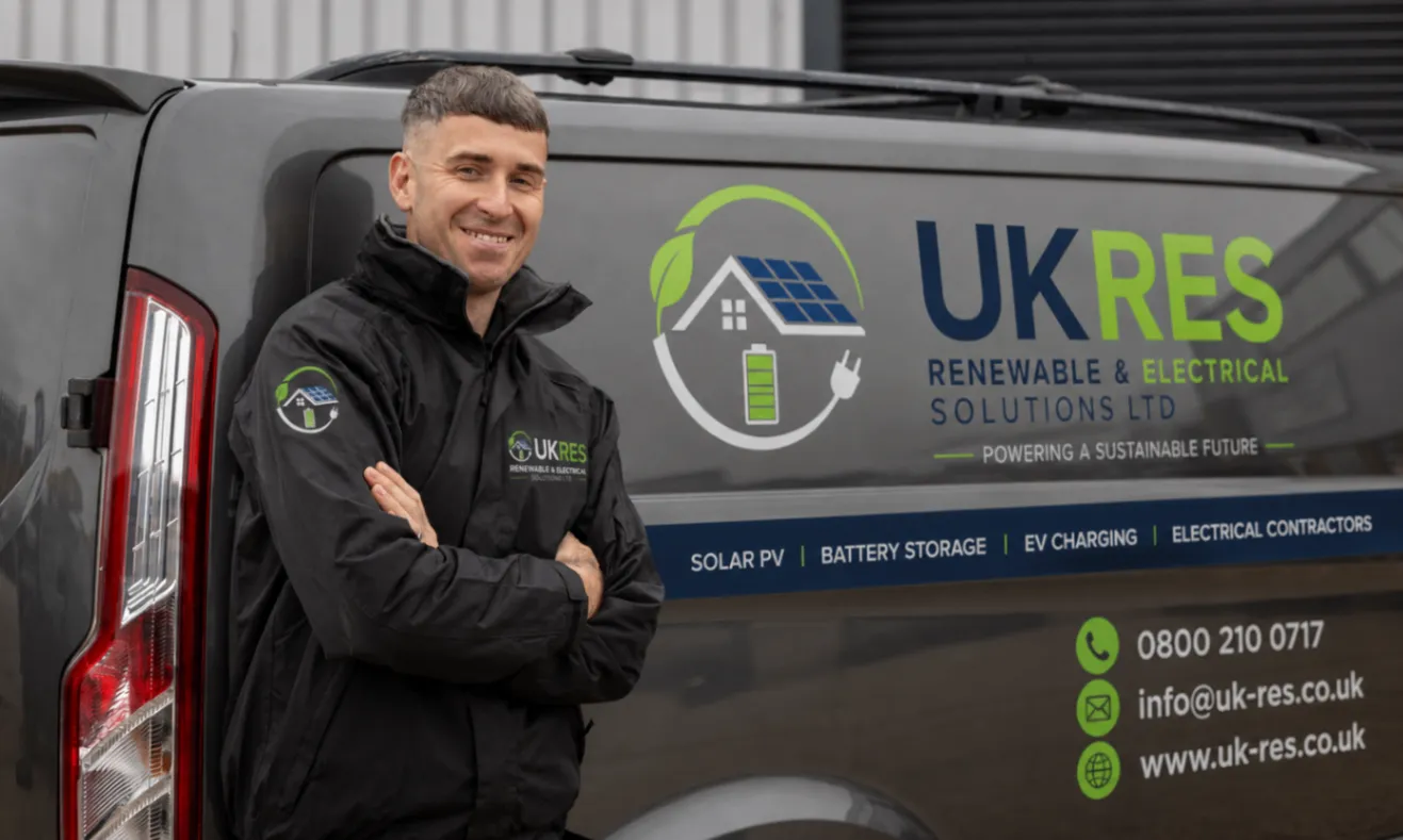 UKRES electrician beside a branded company vehicle